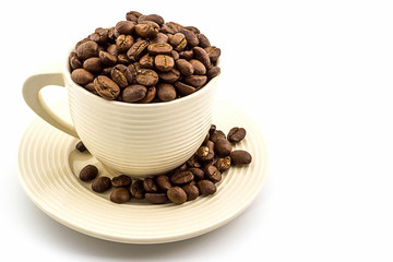 Brown roasted coffee beans in coffee cup