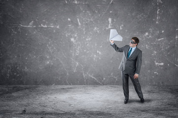 Businessman with paper plane and goggles