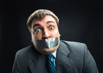 Man with mouth covered by masking tape