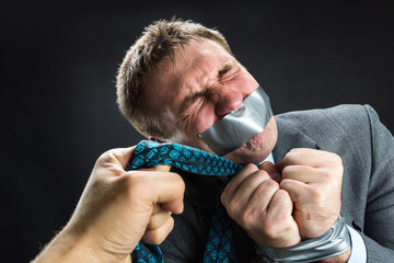 Man with mouth covered by masking tape