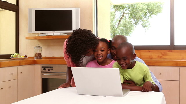 Family looking at laptop together