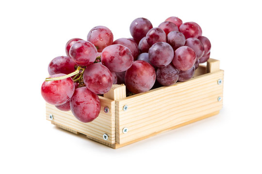 Wooden box with red grapes