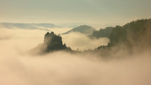 Magnificent misty sunrise in a mountain of sandstone rocky park