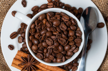 Coffee beans and coffee cup close-up.