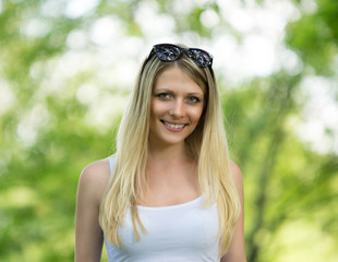 Portrait of beautiful blond woman in garden