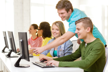 smiling students in computer class at school