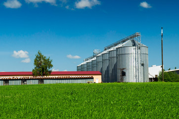 Fototapeta na wymiar Farmland and silos for agricultural goods