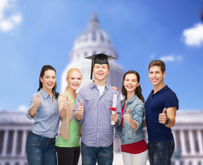 group of students with diploma showing thumbs up