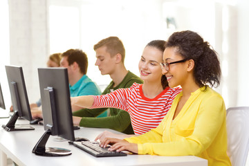 smiling students in computer class at school