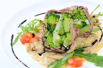 Timbale from beef from a broccoli, cheese and sauce from mushroo