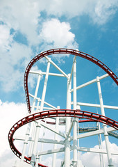 Roller of coaster against blue sky.