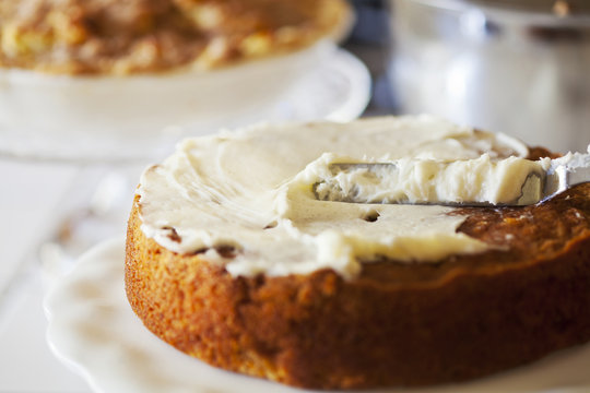 Carrot cake being frosted