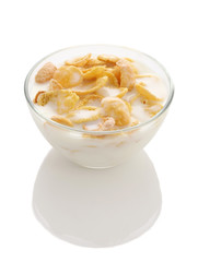 Cornflakes in a glass bowl with yogurt on white background