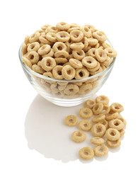 healthy cereal rings in a glass bowl on a white background