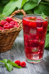 Juice of fresh raspberries served with ice in a glass