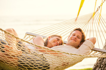 Couple relaxing in tropical hammock