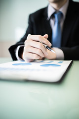 business report and man hand with pen