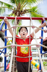 Obraz premium Happy asian child playing on playground
