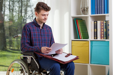 Disabled man viewing documents