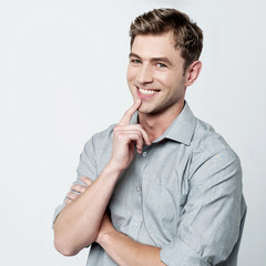 Confident young casual man thinking