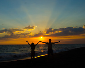 Couple holding hands and enjoying the sunset