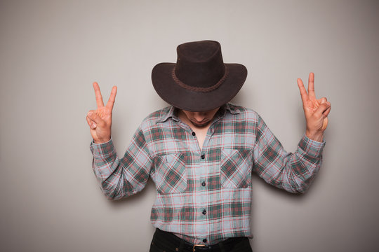 Young cowboy against a green background