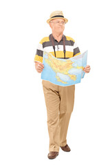 Mature tourist walking with map in his hands