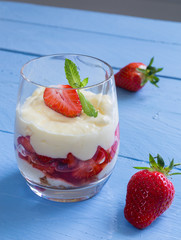 Vanillepudding mit beschwipsten Erdbeeren auf Holz