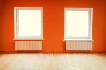 Empty orange room with two windows