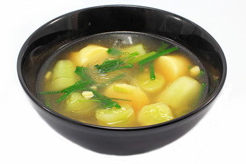 Thai soup with egg tofu and gourd in bowl