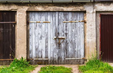 Ruined brick wall closed steel door