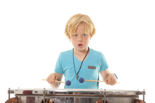 young boy playing kettledrum