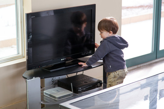 Boy operating a television