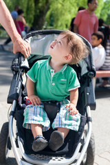 Naklejka premium Close-up of a boy sitting in a baby carriage