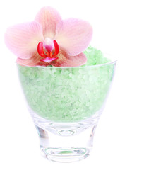 Color sea salt in glass bowl and  orchid flower, isolated