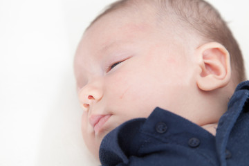 Close-up of a baby boy sleeping on the bed