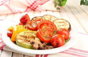 Delicious grilled vegetables on plate on table close-up