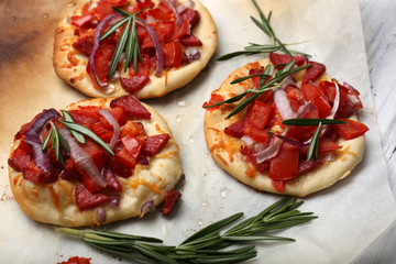 Small pizzas on baking paper close up