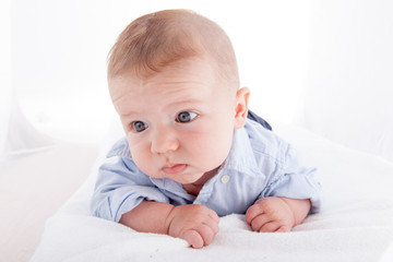 Close-up of a baby boy lying on the bed