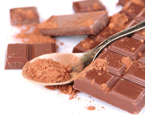 Cocoa powder and dark chocolate isolated on white