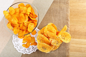 Homemade potato chips in glass bowls on table