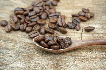Fototapeta premium Coffee beans on an old wooden background