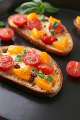 Tasty bruschetta with tomatoes in pan, close up