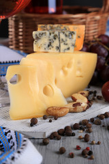 Different kinds of cheese with wine on table close-up