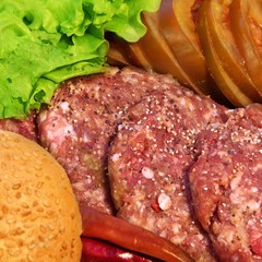 Raw beef patties with vegetables