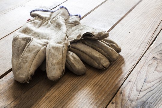 Old Working Gloves Over Wooden Table, Construction Tools