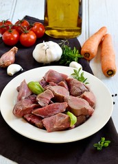 Raw beef for boeuf bourguignon with vegetables
