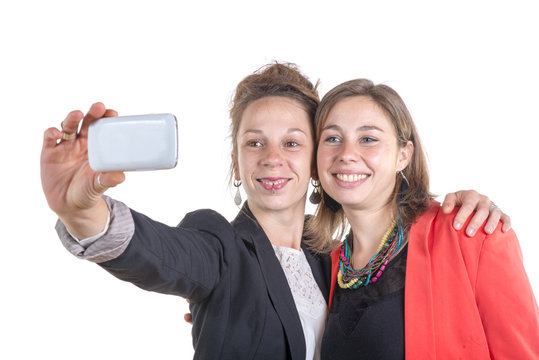 two pretty teen girls taking selfies with her smart phone
