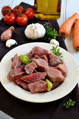 Raw beef for boeuf bourguignon with vegetables