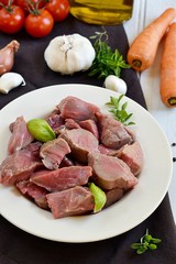 Raw beef for boeuf bourguignon with vegetables